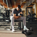 Black hex rubber dumbbells with chrome handles on gym floor