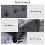 Light gray recliner armchair with nailhead trim, button tufting, and solid wood legs
