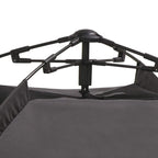 Close-up of black pop-up tent frame and dark fabric base