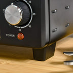 Black mini oven front panel with large temperature knob and glowing power light