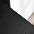 Close-up of dark grey fabric drawer side panel on a chest of drawers