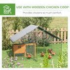 Galvanized chicken coop in a yard setting with weather cover on the roof