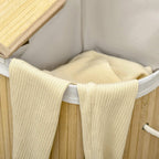 Interior of natural bamboo laundry basket with removable gray liner and rope handles