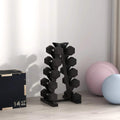 Black five-tier dumbbell storage rack on floor with cradle tiers visible.