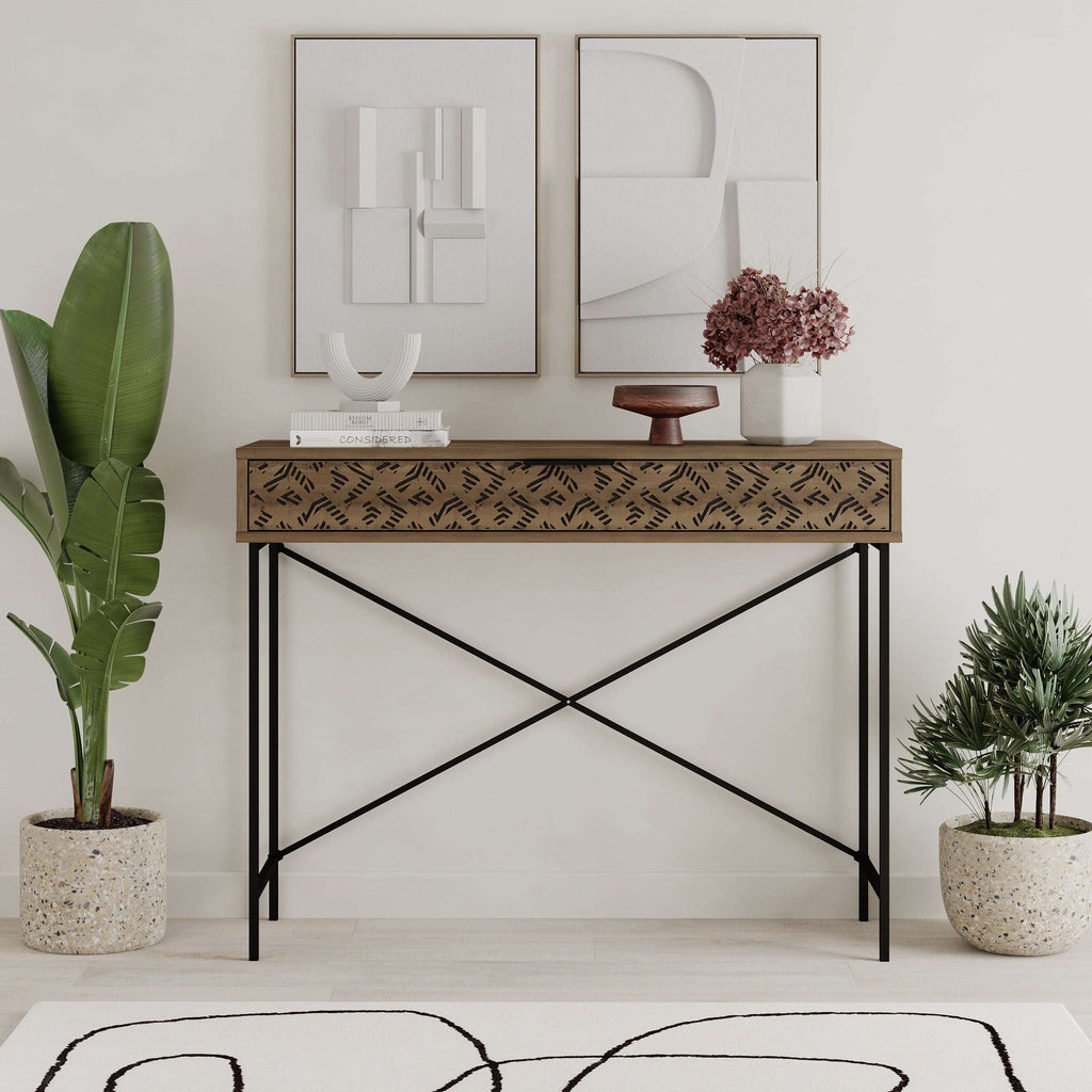 Console display unit with dark wood top, patterned drawer panel, and black metal X-frame legs