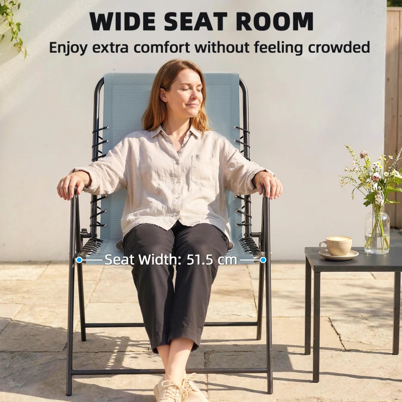 Light grey folding garden chair with wide seat, high back, and armrests; person seated