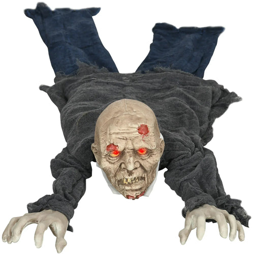 Life-size crawling zombie prop with glowing red eyes, tattered grey arms