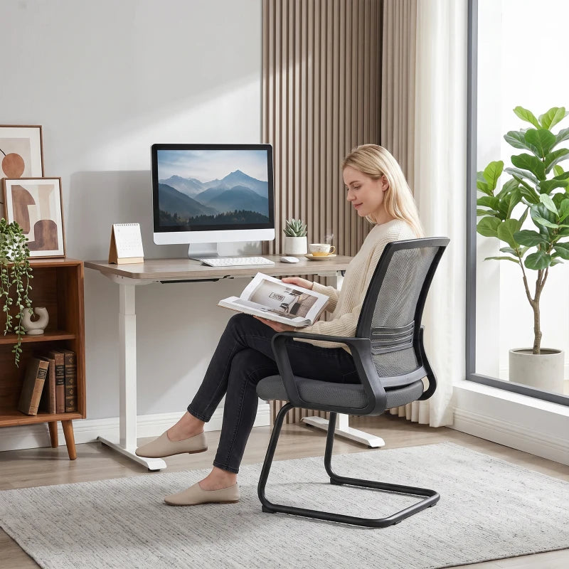 Dark grey ergonomic mesh office chair with padded seat and sled base