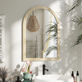 Beige arched wall mirror with textured grooved frame reflecting the room