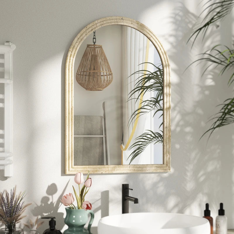 Beige arched wall mirror with textured grooved frame reflecting the room