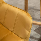 Yellow upholstered armrest and seat corner with quilted stitching and curved back