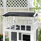Close-up of white three-tier cat house roof and railings with dark grey interior panels.