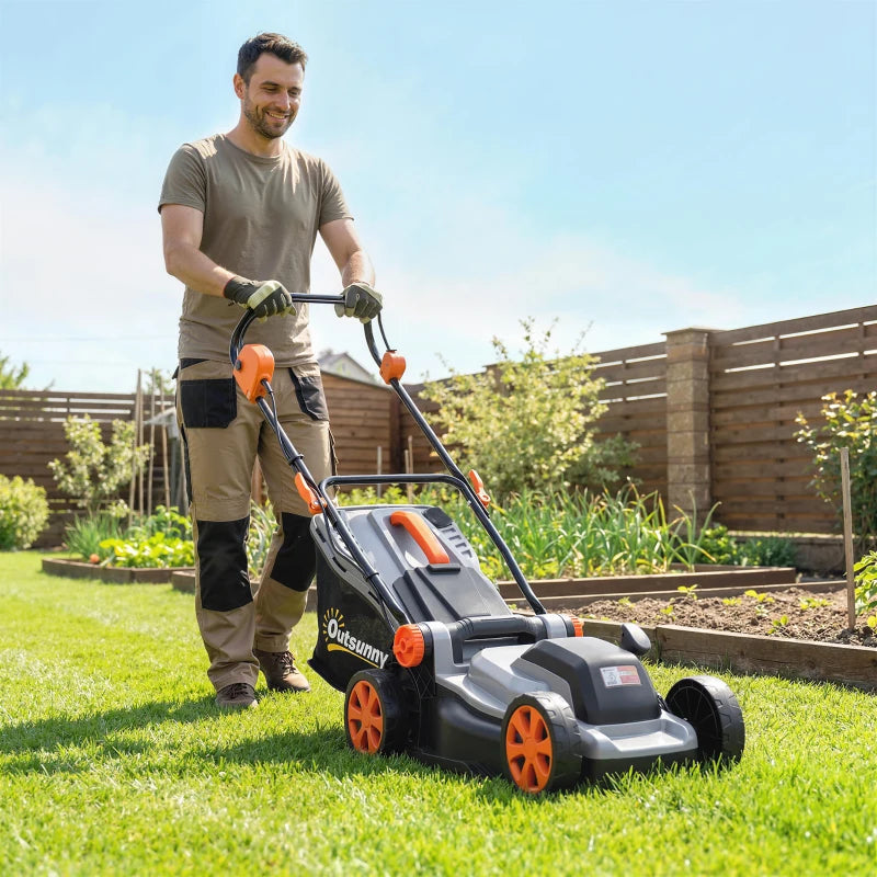 Cordless lawn mower with light grey deck and orange wheels, mowing grass