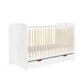 White wooden cot bed with vertical slats and under-drawer storage