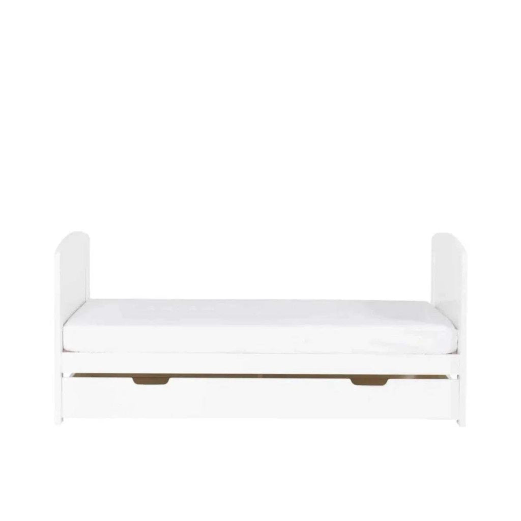 White cot bed with padded base mattress support and open under-drawer