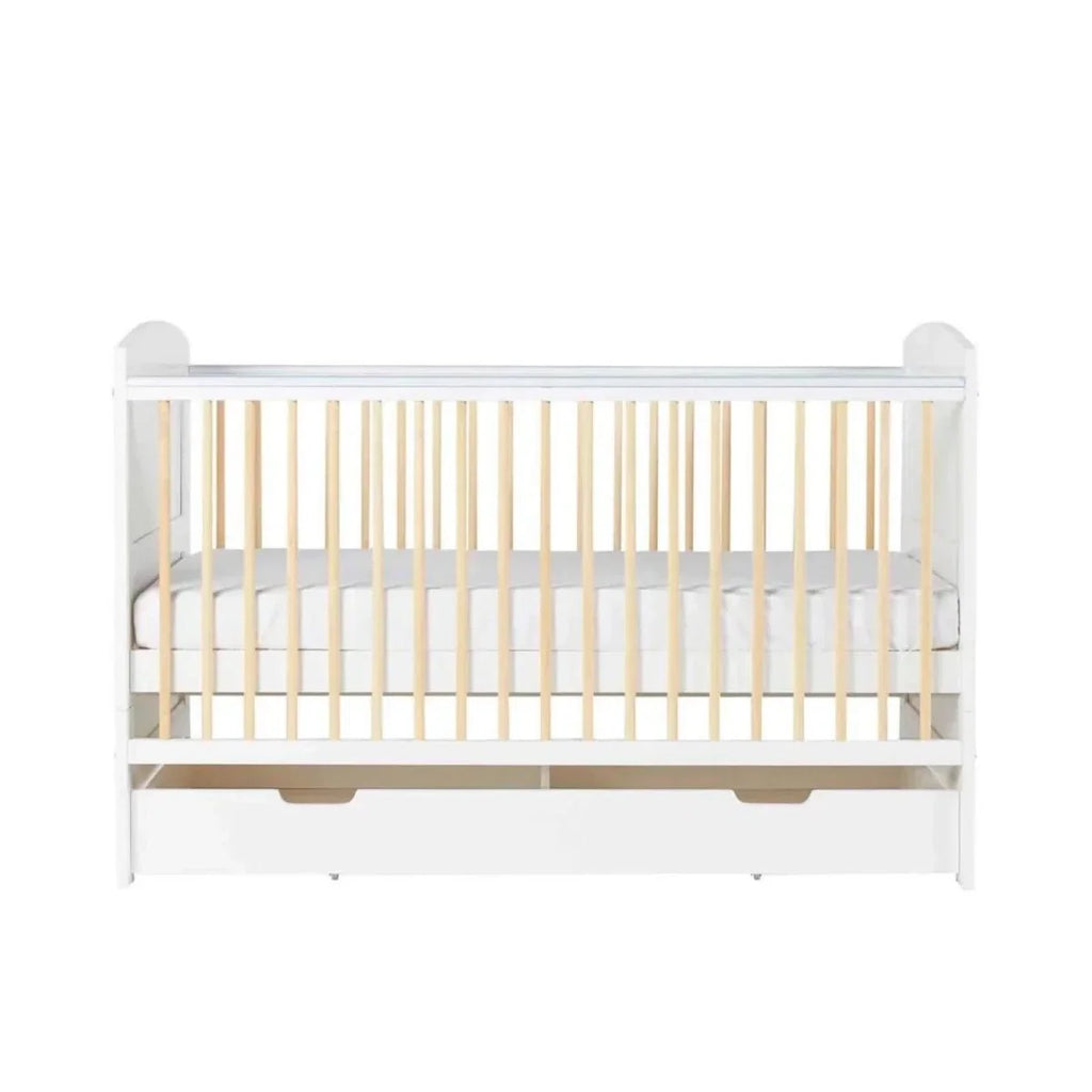 White cot bed front view with natural wood slats and two under-drawer bays