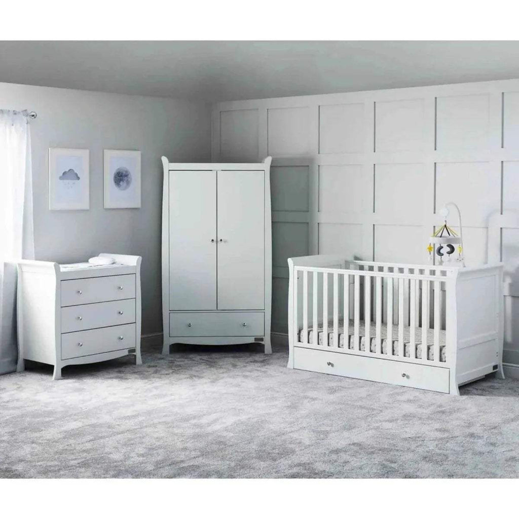 White nursery furniture set with cot and matching dresser and wardrobe