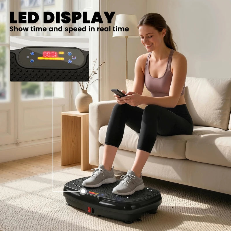 Black vibration plate machine with LED display and person doing workout on it