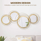Gold-tone metal wall mirror set with five interlocking circular frames, polished metal loops