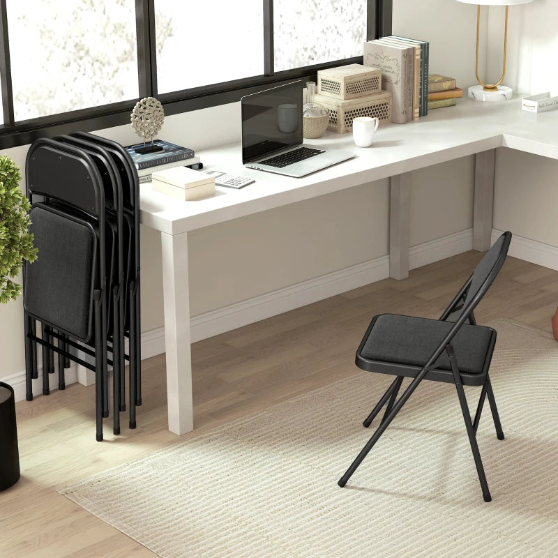Black cushioned folding chair with padded seat and back, metal legs in a room