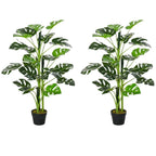 Set of 2 artificial monstera trees with green leaves in black nursery pots