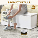 White storage chest with open lid as a person places shoes and personal items inside.