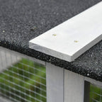Close-up of light grey catio roof edge with textured waterproof asphalt shingle surface.