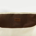 White folding chair fabric with brown logo patch on the back panel