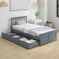 Grey pine single bed with headboard and two open storage drawers under the frame