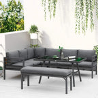 Grey L-shaped outdoor dining sofa set with table and bench plus matching seat cushions