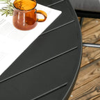 Close-up of black slatted metal tabletop edge