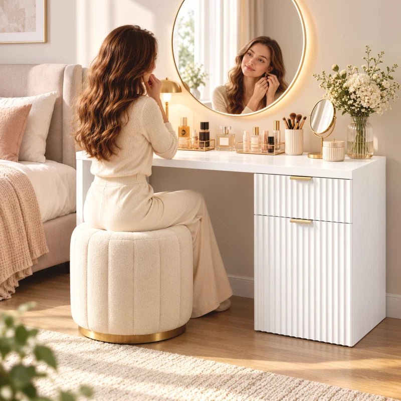 White computer desk with side cabinet drawers and gold bar handles in a home setting