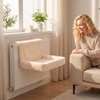 Cream plush cat radiator bed on a radiator with padded seat and backrest