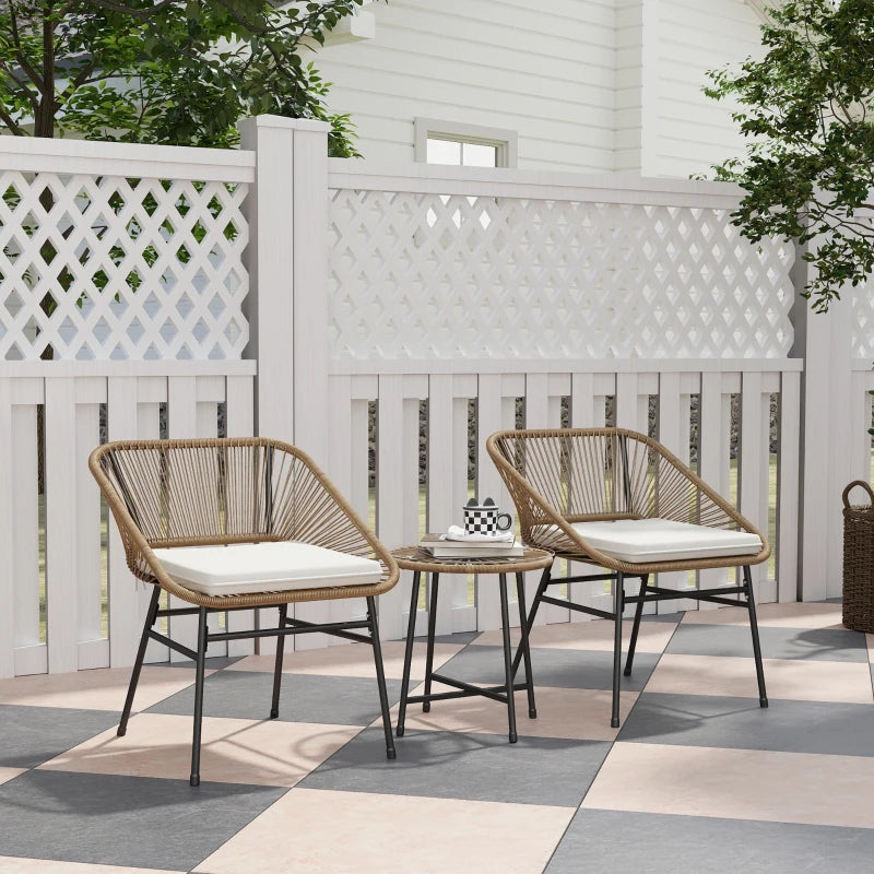 Outdoor rattan bistro set with two chairs, white cushions, and round side table