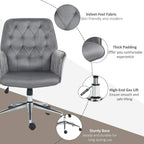 Dark grey upholstered computer chair with tufted back, thick padding, and gas-lift base