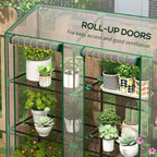 Mini greenhouse with clear roll-up doors and green frame, wire shelves with potted plants