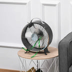 Black portable table fan with protective front grill on a wooden surface