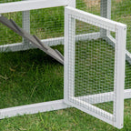 Grey rabbit hutch corner with wire panel door and ramp leading into the run