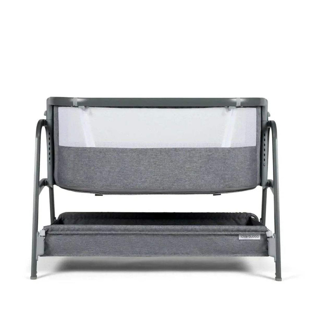 Grey bedside crib front view with fabric wall panel and lower padded insert.