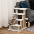 White cat climbing stairs beside sofa, with padded steps, scratching posts, and dangling ball