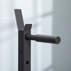 Black padded dip handle attached to the multifunction rack frame