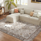 Beige vintage area rug under sofa, featuring ornate medallion and border pattern