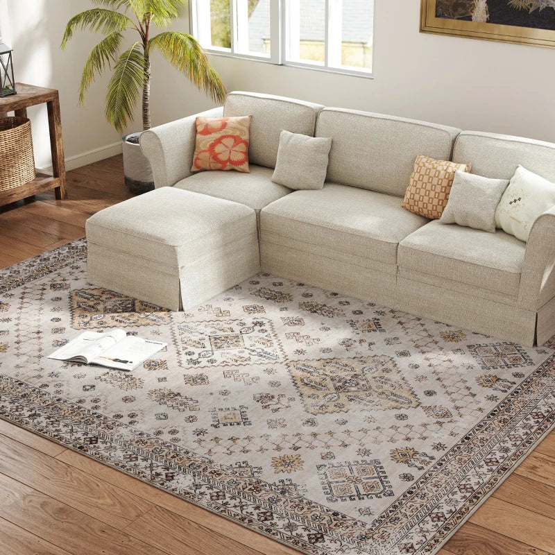 Beige vintage area rug under sofa, featuring ornate medallion and border pattern