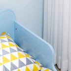 Blue bed safety side rail and patterned bedding with geometric yellow and white
