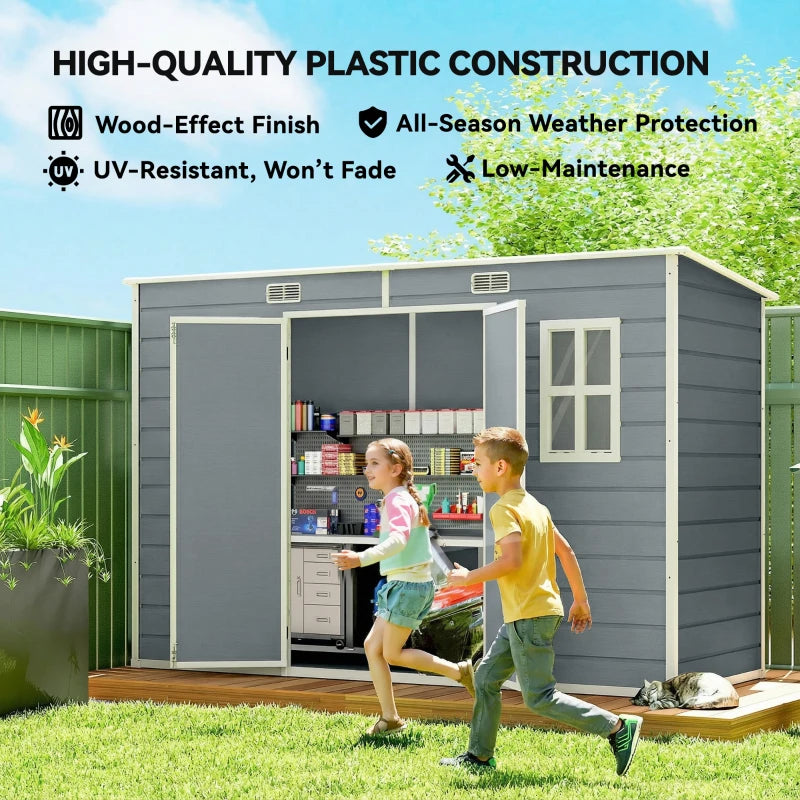 Grey resin garden shed with side window and open doors showing shelves.