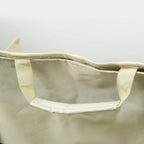 White carrying bag with wide opening and handles for folding chair