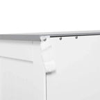 Anti-tipping strap attachment under the cabinet top, secured with visible metal screws