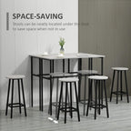 Grey bar table with four round stools positioned tucked under the table for space saving