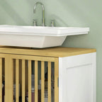 Corner view of white under-sink cabinet with bamboo slat front beneath sink
