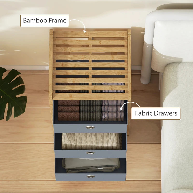 Bamboo-framed light grey fabric drawer dresser with three pull-out drawers and metal-ring pulls